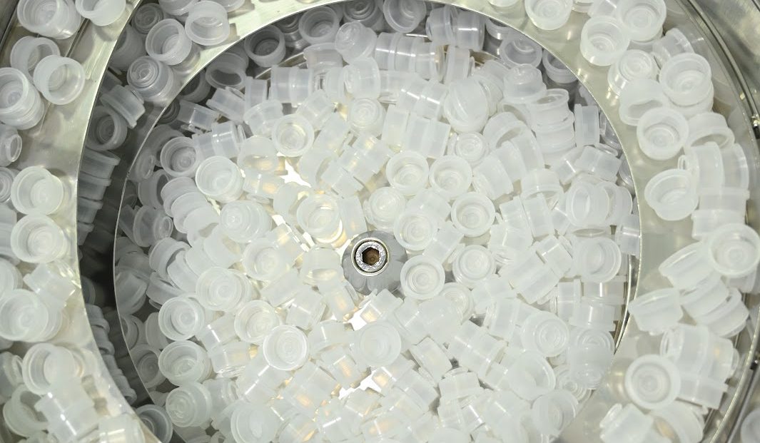 Bottle caps in the feeder bowl, from above
